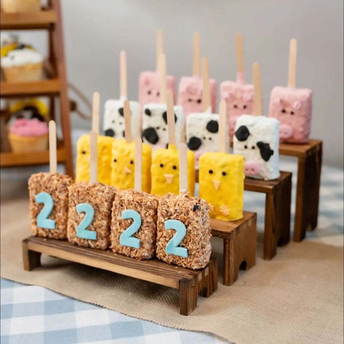 Farm themed cake pops and number treats on a wooden stand