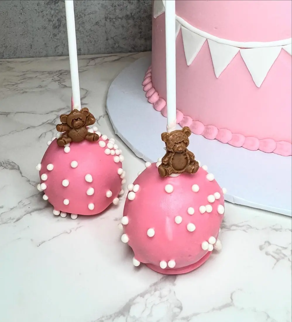 Pink cake pops with little sugar teddy bears