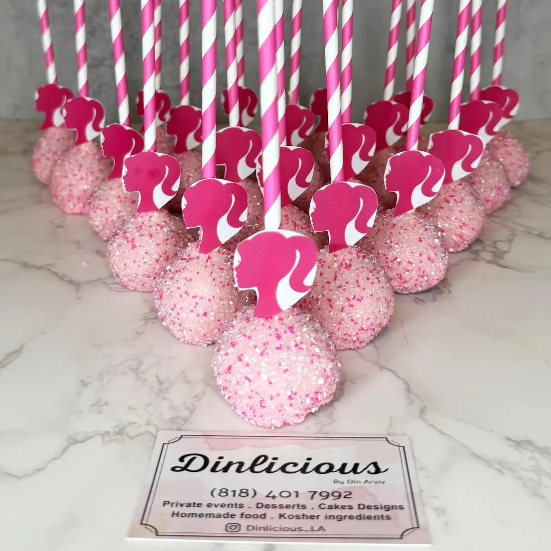 Pink cake pops with sprinkles and striped sticks