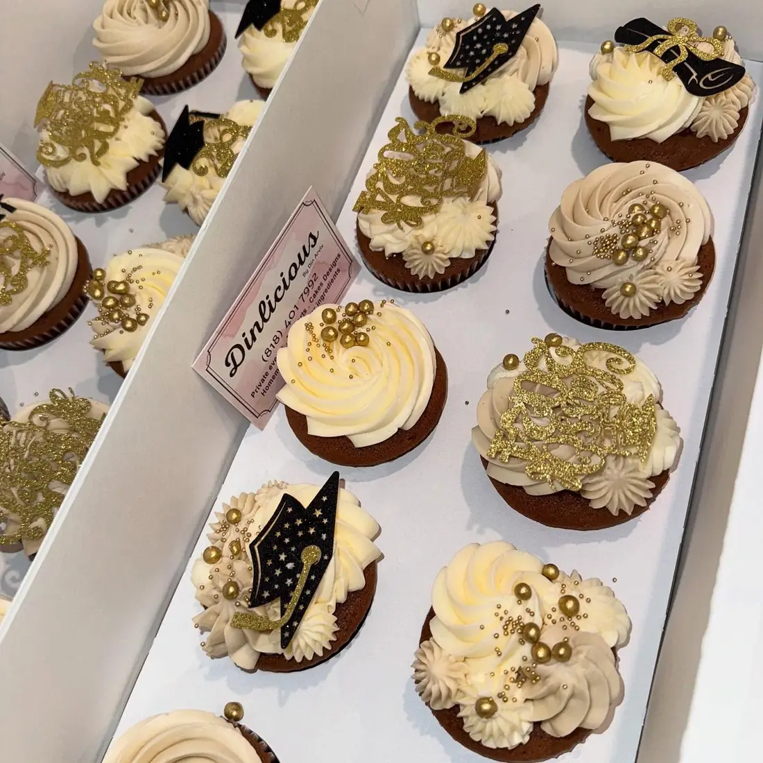 Chocolate cupcakes with cream swirls and gold leaf