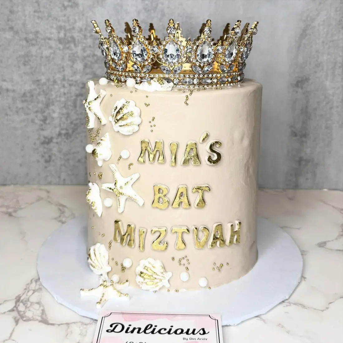 Bat Mitzvah cake with silver crown and seashell details by Cakes by Din