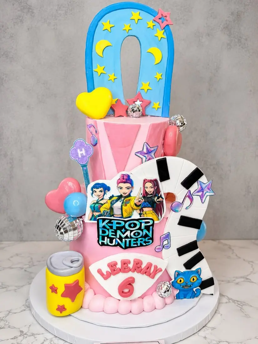 Two-tier colorful number cake with cartoon characters by Cakes by Din