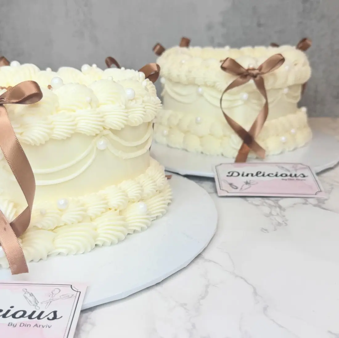 Pair of vintage heart cakes with ribbon bows by Cakes by Din