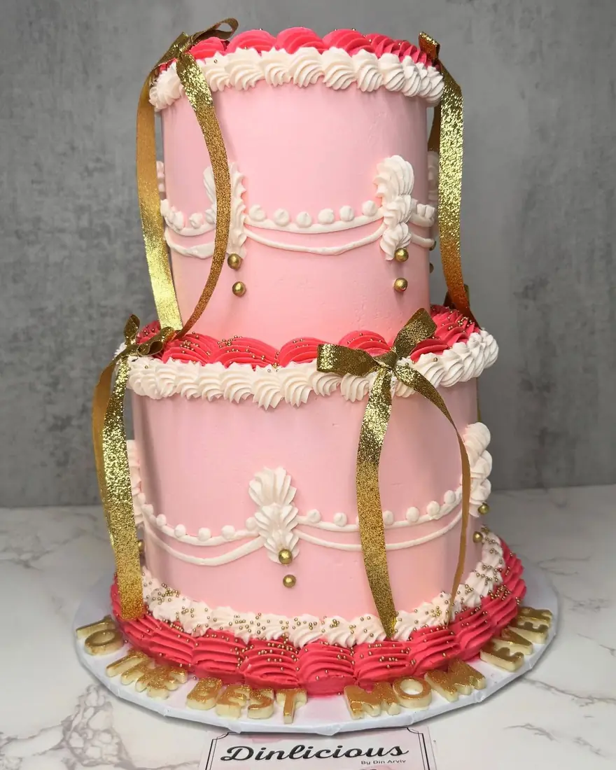Two-tier pink vintage-style buttercream cake by Cakes by Din
