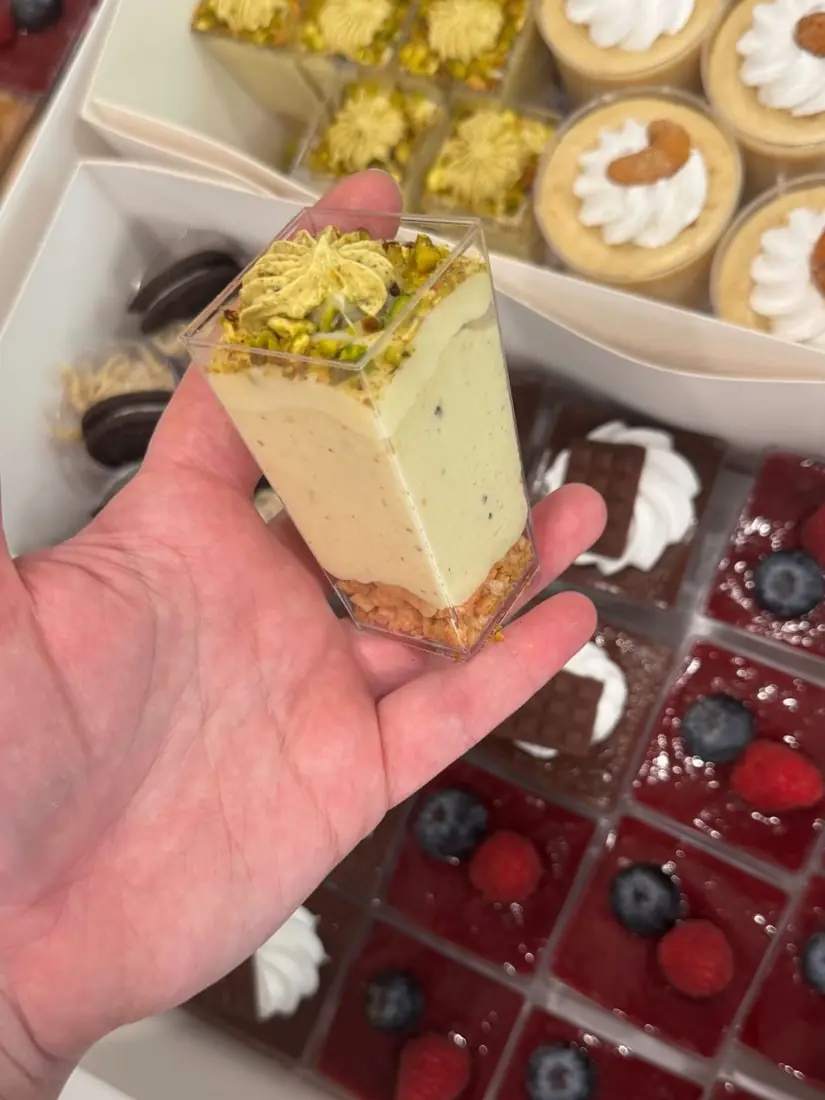 Cheesecake dessert slice with mini pies in the background