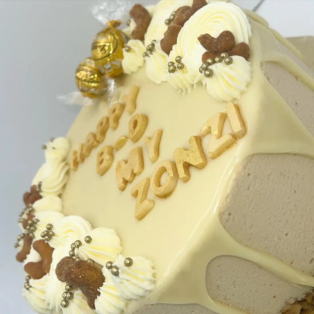 Cashew and white chocolate mousse cake decorated with candied nuts