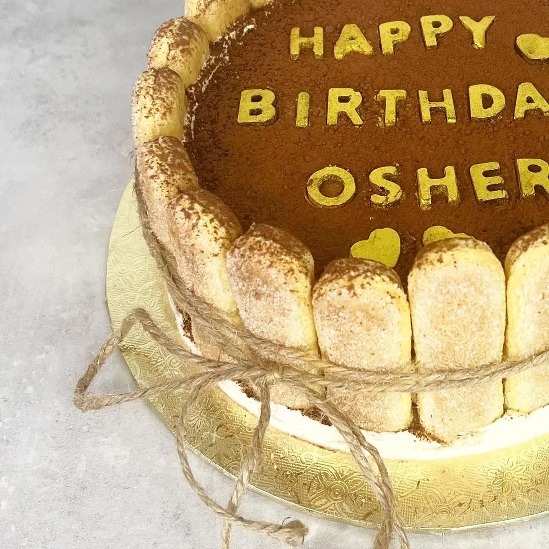 Ladyfinger-wrapped mousse cake with a happy birthday message