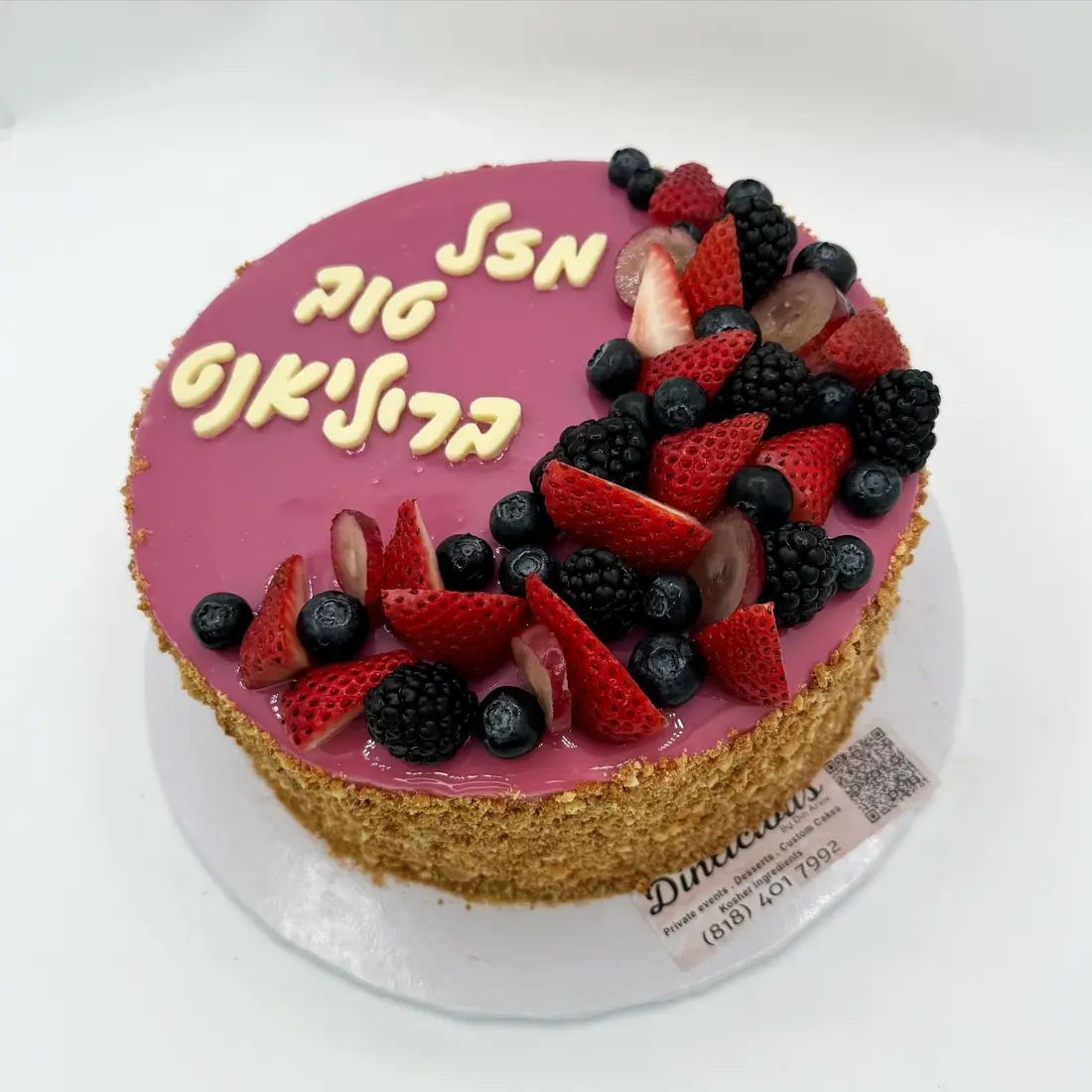 Cheese mousse cake with pink mirror glaze and fresh berries